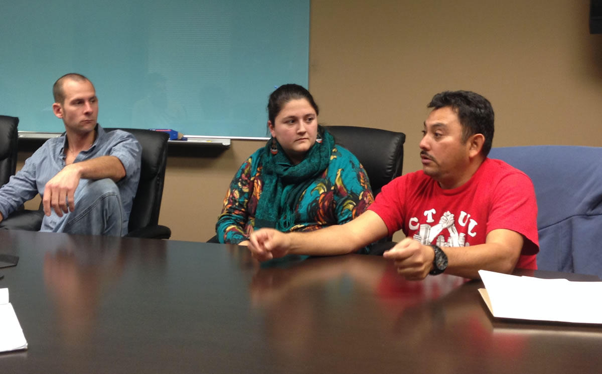 Elmer Santacruz of CTUL calls on U.S. Senator Amy Klobuchar to speak out forcefully for fair trade as Nolan Lenzen of the Landstewardship Project and Ruth Schultz, also of CTUL, look on. Workday Minnesota photo