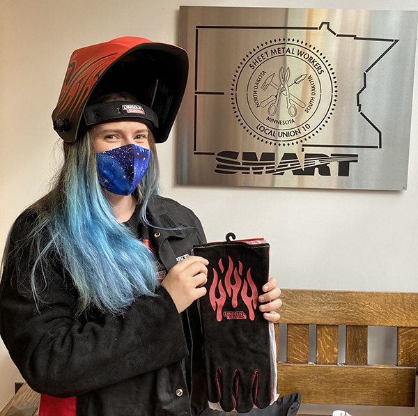 A Sheet Metal Workers Local 10 apprentice shows off her new PPE from Lincoln Electric & the Minnesota Training Partnership