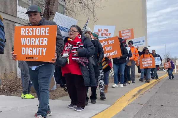 Workers marching on a picket line.