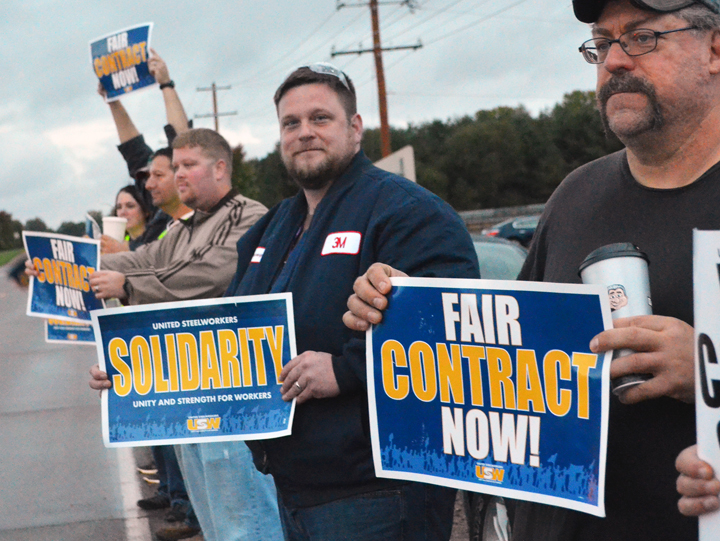 R to L: Jeff Puhl, Jeremy Hackbarth and Josh Noltin stand up for a fair contract outside 3M’s Cottage Grove chemicals plant. Union Advocate photo