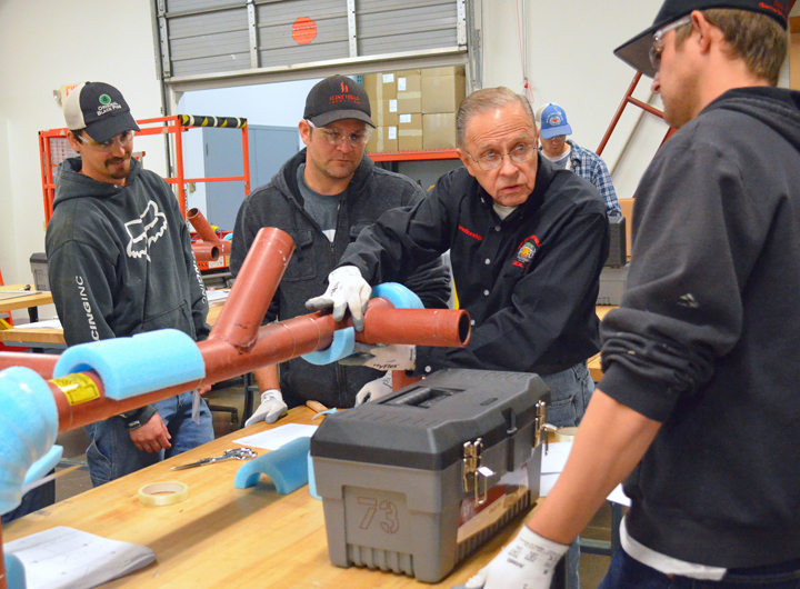 Heat and Frost Insulators Local 34 instructor Lee Houske drives home a point to apprentices about pipe insulation.